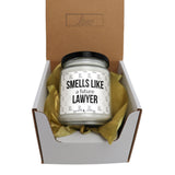 a candle in a box that says smells like a future lawyer