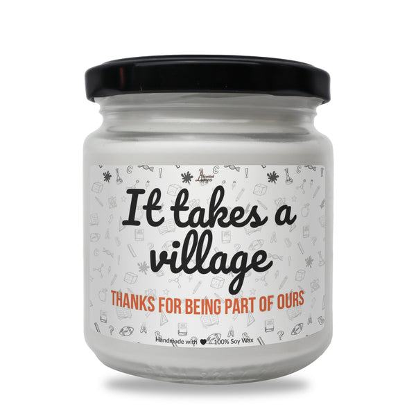 a white jar with a black lid that says it takes a village thanks for being