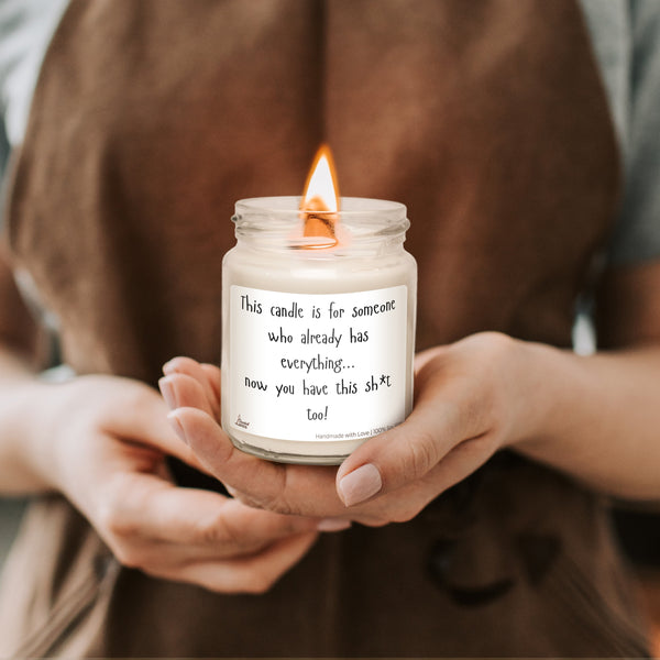 a woman holding a candle with a quote on it