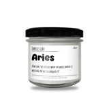a jar of white candles with a black lid